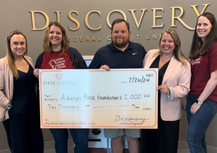 Discovery Federal Credit Union presents the Adalyn Rose Foundation with a donation check.