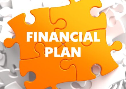 An orange puzzle piece coming together saying financial plan.