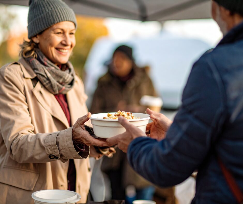 Woman handing out food at event